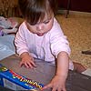 Opening presents takes a lot of concentration.<br><div class='photoDatesPopup'><br>from Emily's Photos taken 5/27/2006 and posted 6/7/2006</div>